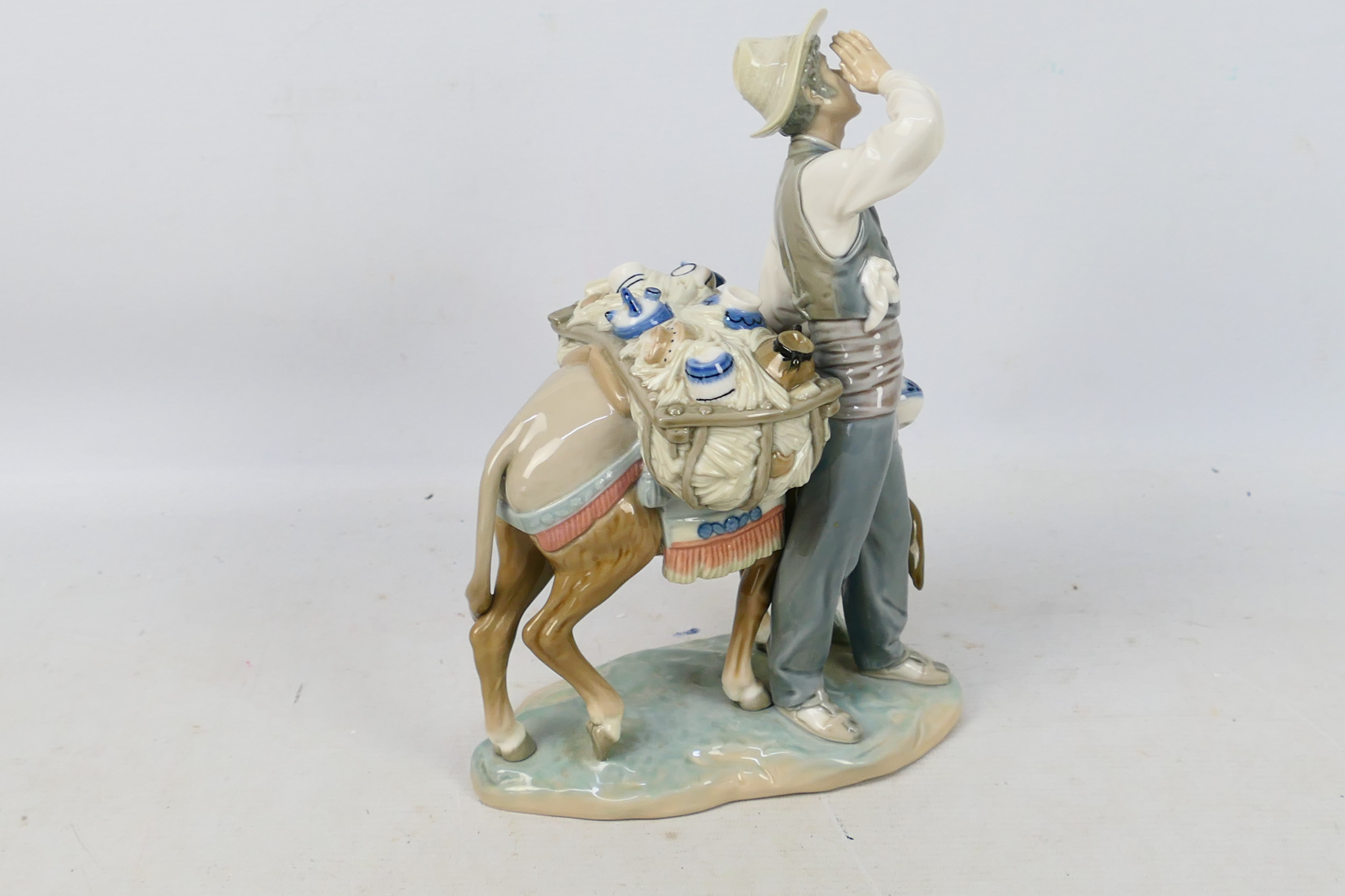 Lladro - A porcelain figural group entitled Peddler # 4859 depicting a pottery seller with his - Image 2 of 5