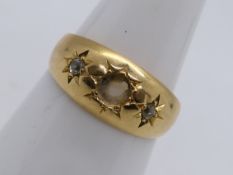A hallmarked 18 carat gold ring with setting for three small diamonds (of which the central stone