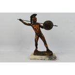 A cast metal figure depicting a Greek warrior with shield and spear, approximately 34 cm (h).