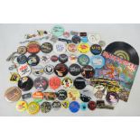 A collection of vintage pin badges, predominantly relating to music / rock bands,