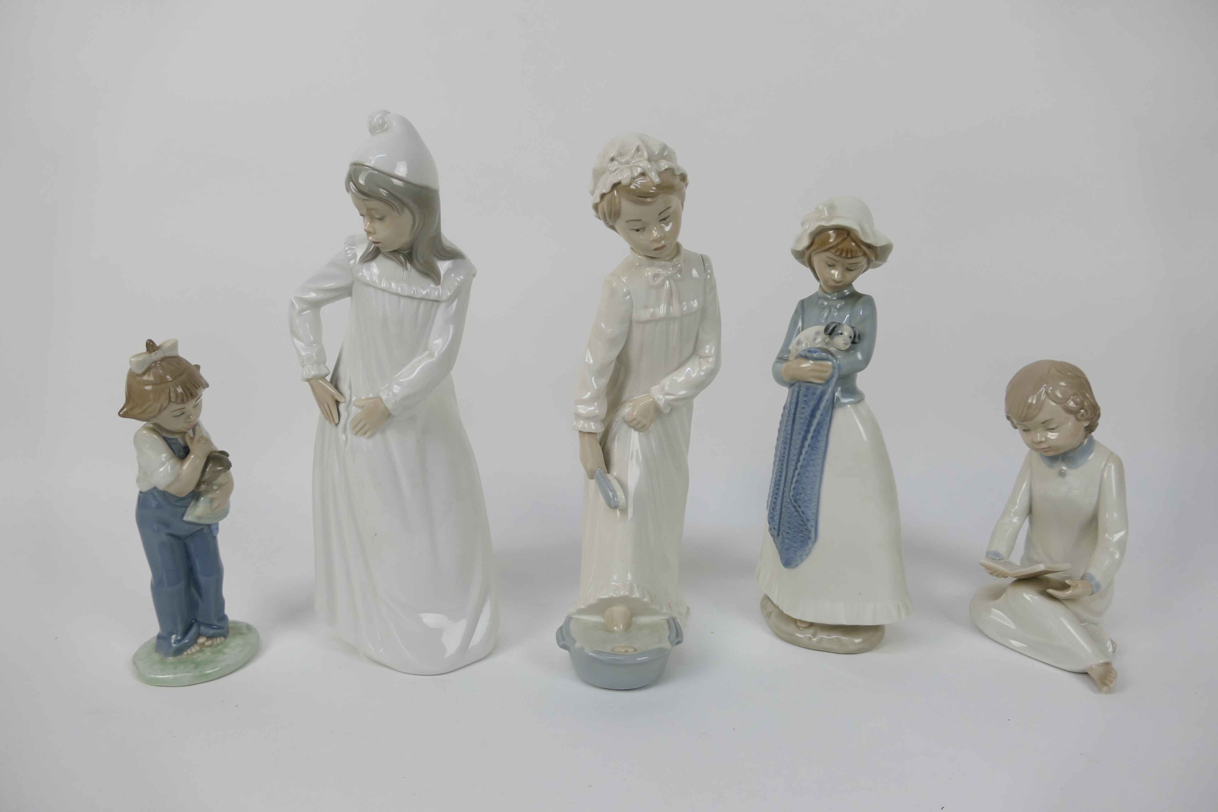 Five Nao figures of children, largest approximately 29 cm (h).