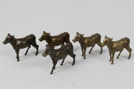 5 x bronze cow figures. All in same sizes. Largest is 4 1/2 cm (l). Appear in good condition.