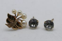 A pair of 9ct gold stone set ear studs (lacking butterflies) and one further 9ct gold and pearl ear