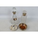 Two silver mounted decanters, one with silver bottle label (sherry),