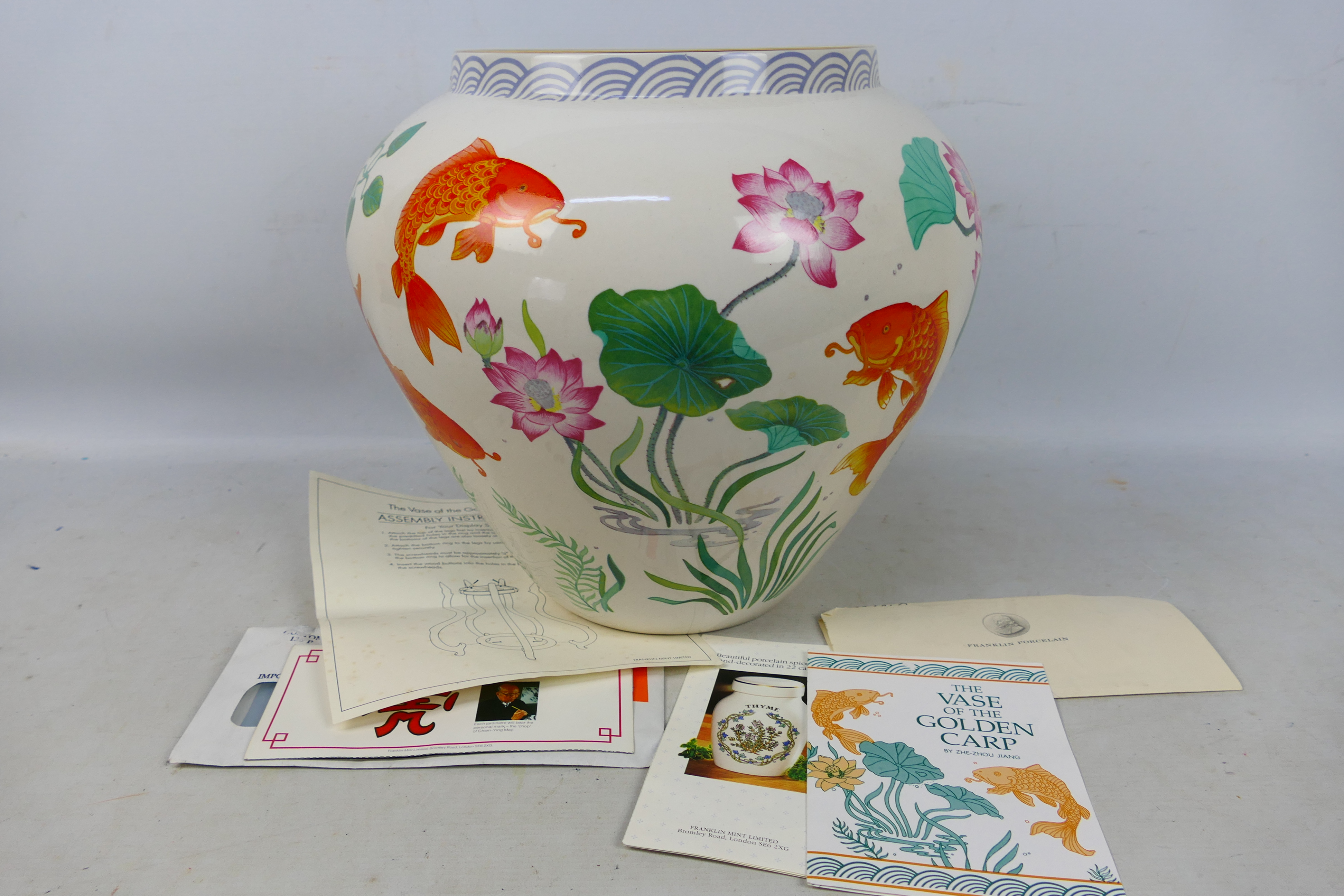 A large vase by Franklin Mint entitled The Vase of The Golden Carp by Zhe Zhou Jiang,