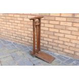 An oak boot jack with two handled top with twin columns and carved recess for boot heel,