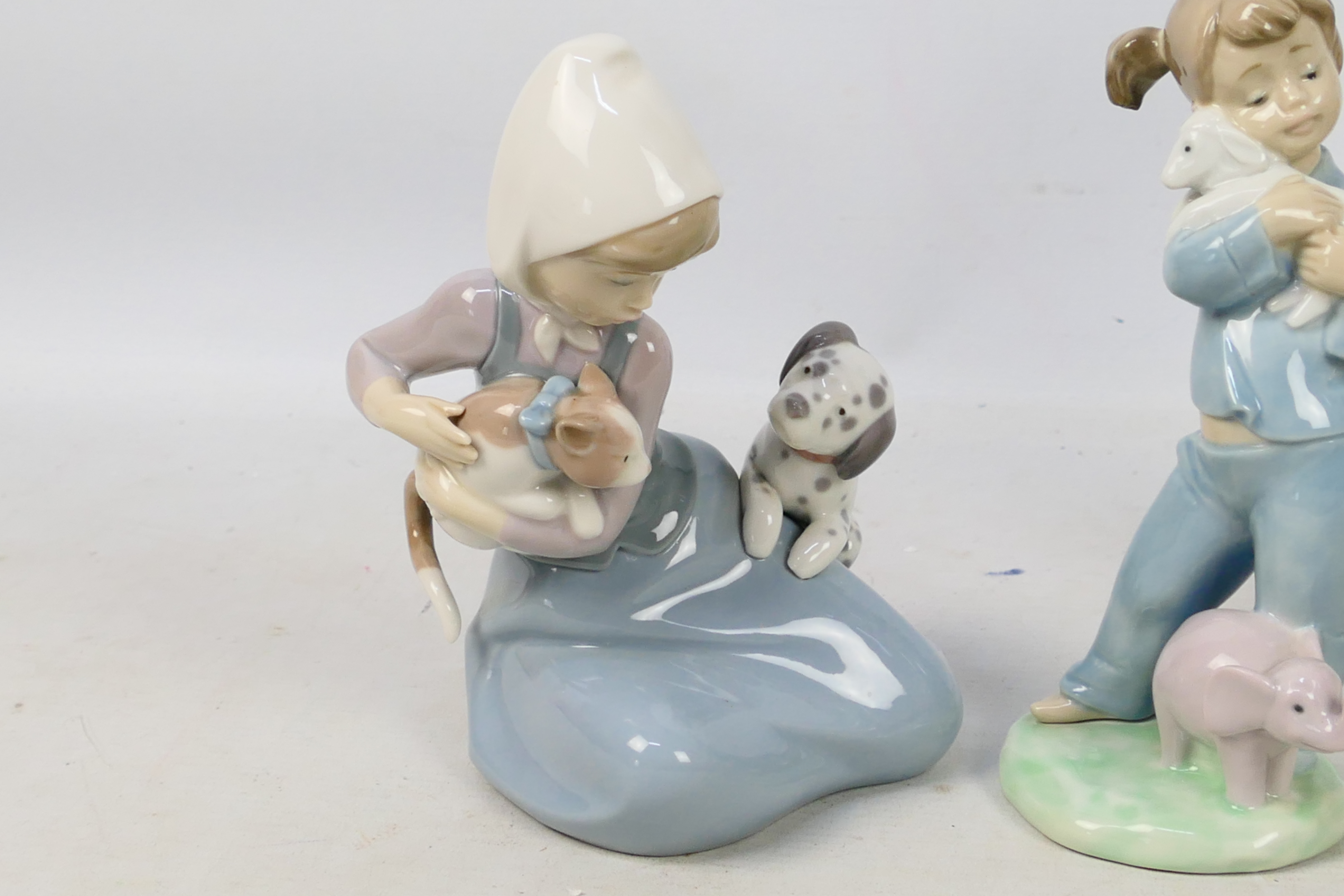 Three Spanish porcelain figures / groups by Lladro and Nao comprising Mirth In The Country # 4920, - Image 2 of 8