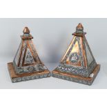 Two copper and white metal pyramids or altar displays with embossed decoration,