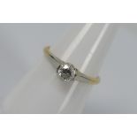 A two-tone, solitaire ring, stamped 18ct, size O, approximately 2.2 grams all in.