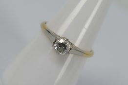 A two-tone, solitaire ring, stamped 18ct, size O, approximately 2.2 grams all in.
