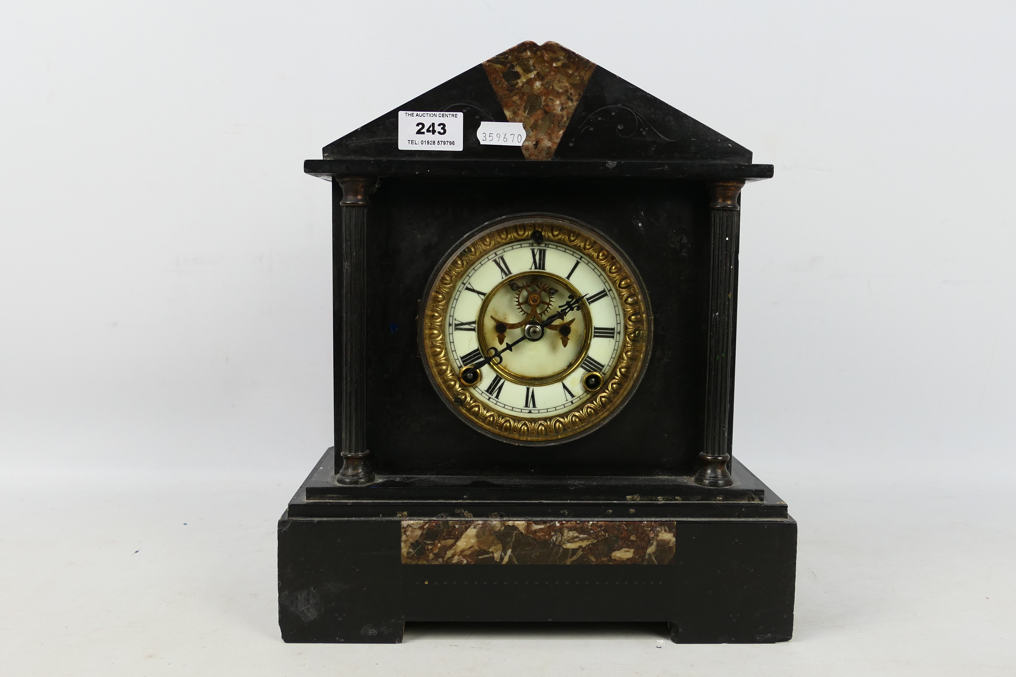 A late 19th or early 20th century black marble cased mantel clock by Ansonia,