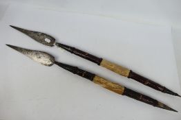 Ethnographica - Two African tribal leather and hide clad short spears, approximately 75 cm (l).
