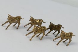 5 x bronze cow figures. All in same sizes. Largest is 4 cm (l). Appear in fair to good condition.