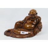 A wooden carving depicting Budai in reclining pose, approximately 18 cm (h),