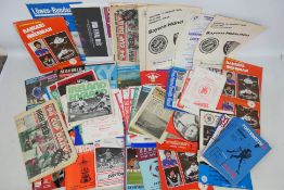 A box of various football programmes, in excess of 100.