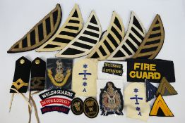 Various cloth insignia to include Kings Own Scottish Borderers patch, musician epaulettes,