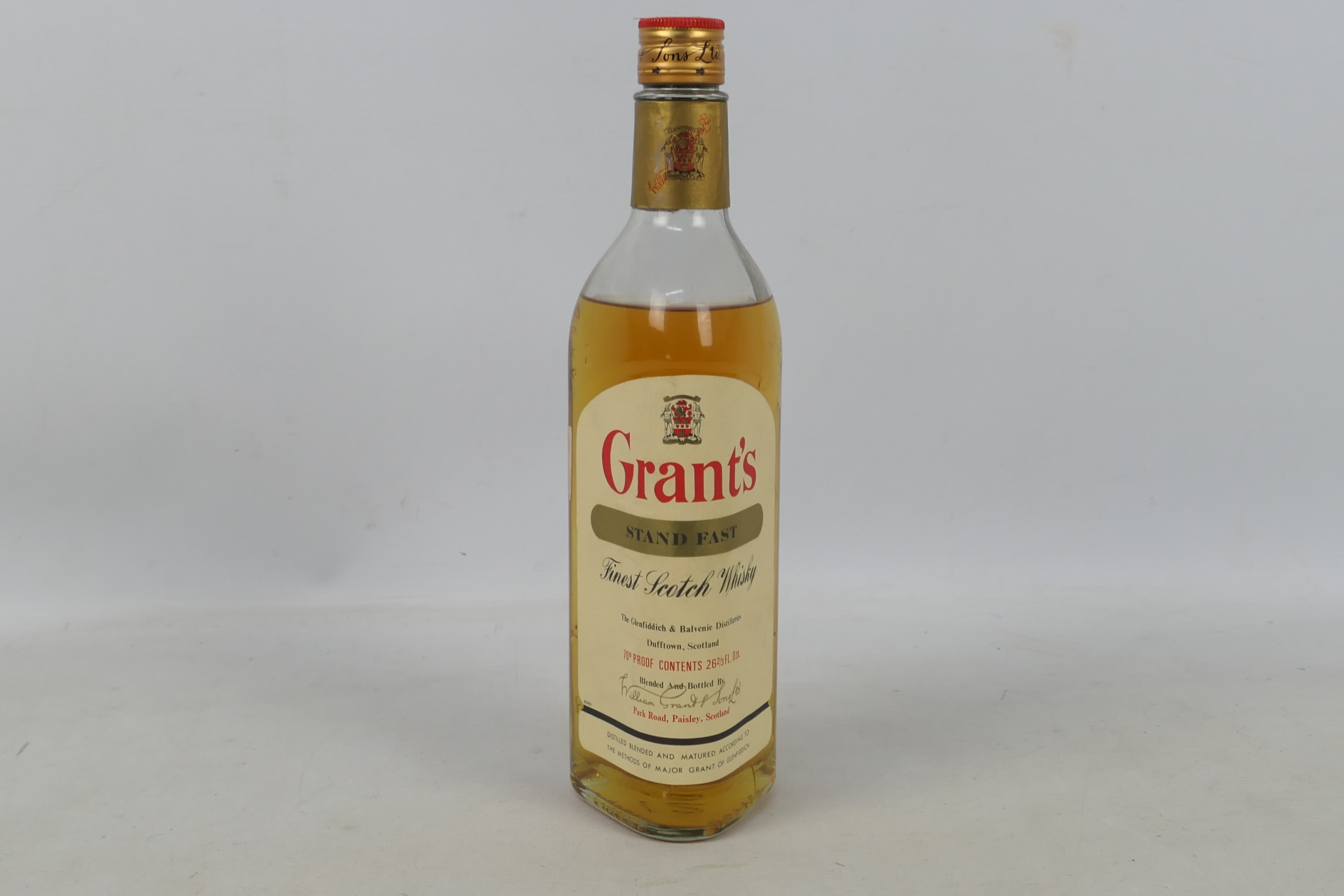 A 26⅔ fl oz bottle of Grants Stand Fast, 70° proof, level lower shoulder, likely a 1970's bottling.