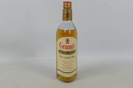 A 26⅔ fl oz bottle of Grants Stand Fast, 70° proof, level lower shoulder, likely a 1970's bottling.