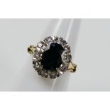 An 18ct yellow gold sapphire and diamond cluster ring, size M, approximately 5.