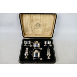 A George V silver, six piece condiment set comprising two open salts (with liners),