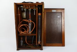 Vintage laboratory equipment contained in wooden case marked Gallenkamp.