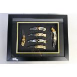 A framed display of six Franklin Mint collectors knives decorated with hunting / nature scenes,