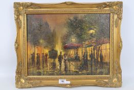 A gilt framed oil on canvas depicting a continental street scene, indistinctly signed lower right,