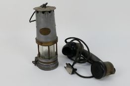 A vintage safety lamp and vintage telephone handset.