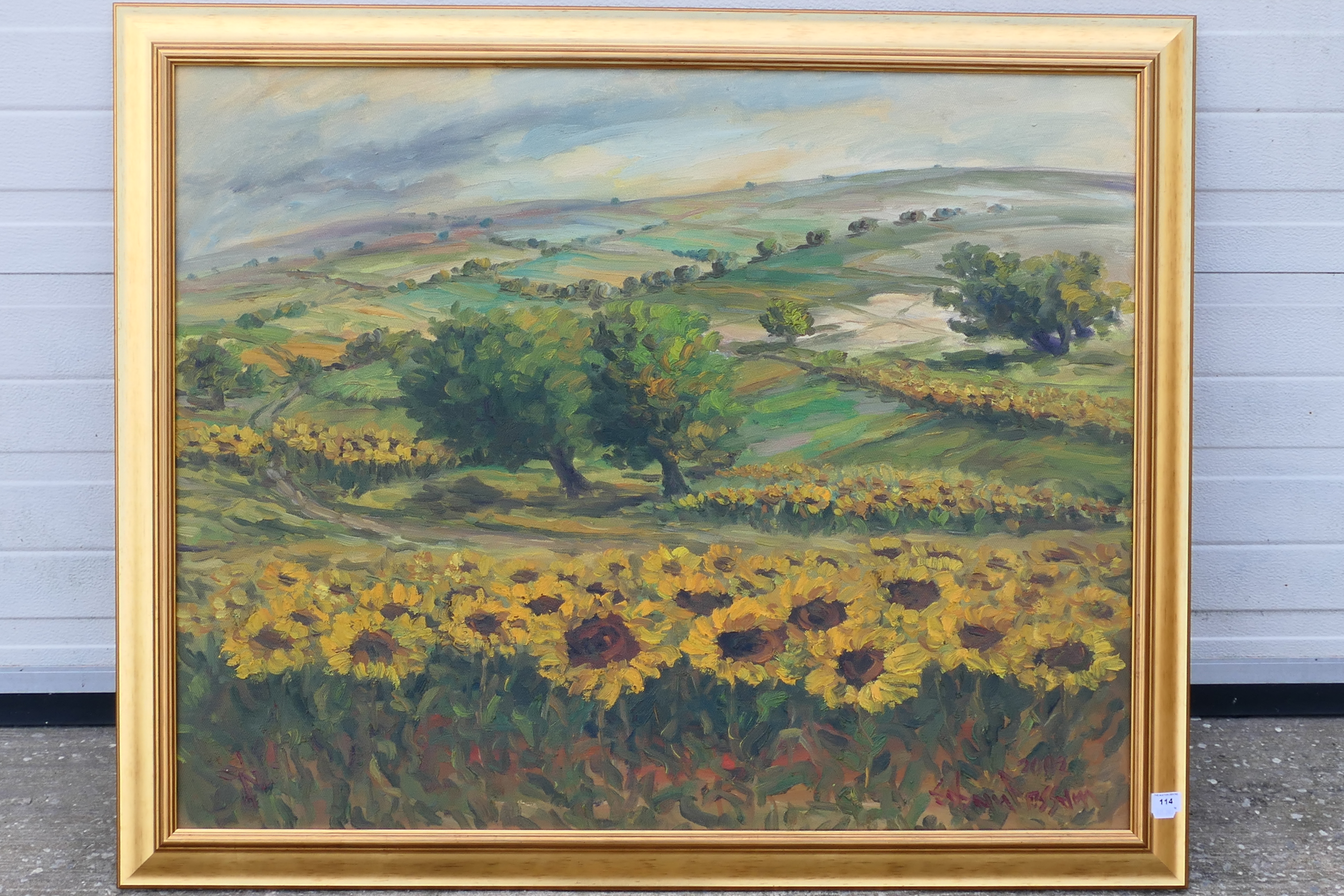 A large oil on canvas landscape scene depicting fields of sunflowers,