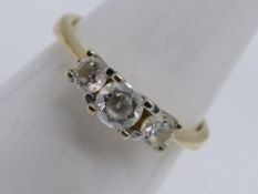 A 14 carat yellow gold ring set with three diamonds, size O, approx 3.