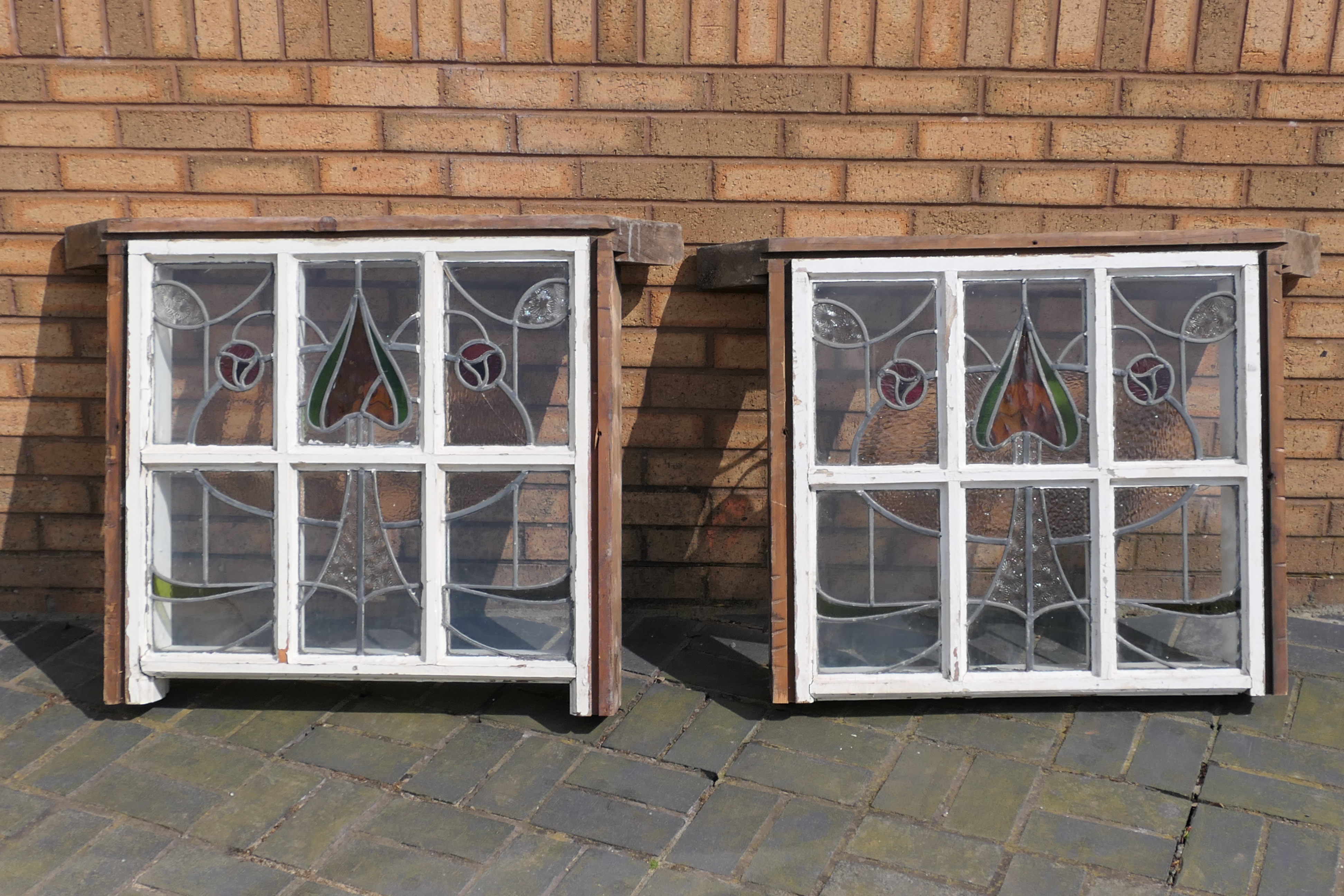 Two Arts and Crafts, leaded and stained glass window panes, approximately 75 cm x 80 cm,