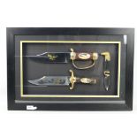 A framed display of three Franklin Mint collectors knives comprising two Bowie type knives and one