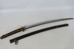 A vintage katana with 68 cm blade, floral decorated tsuba and fuchi,