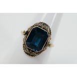 A rose metal (stamped 9ct) and blue zircon dress ring, size N+½, approximately 3 grams.