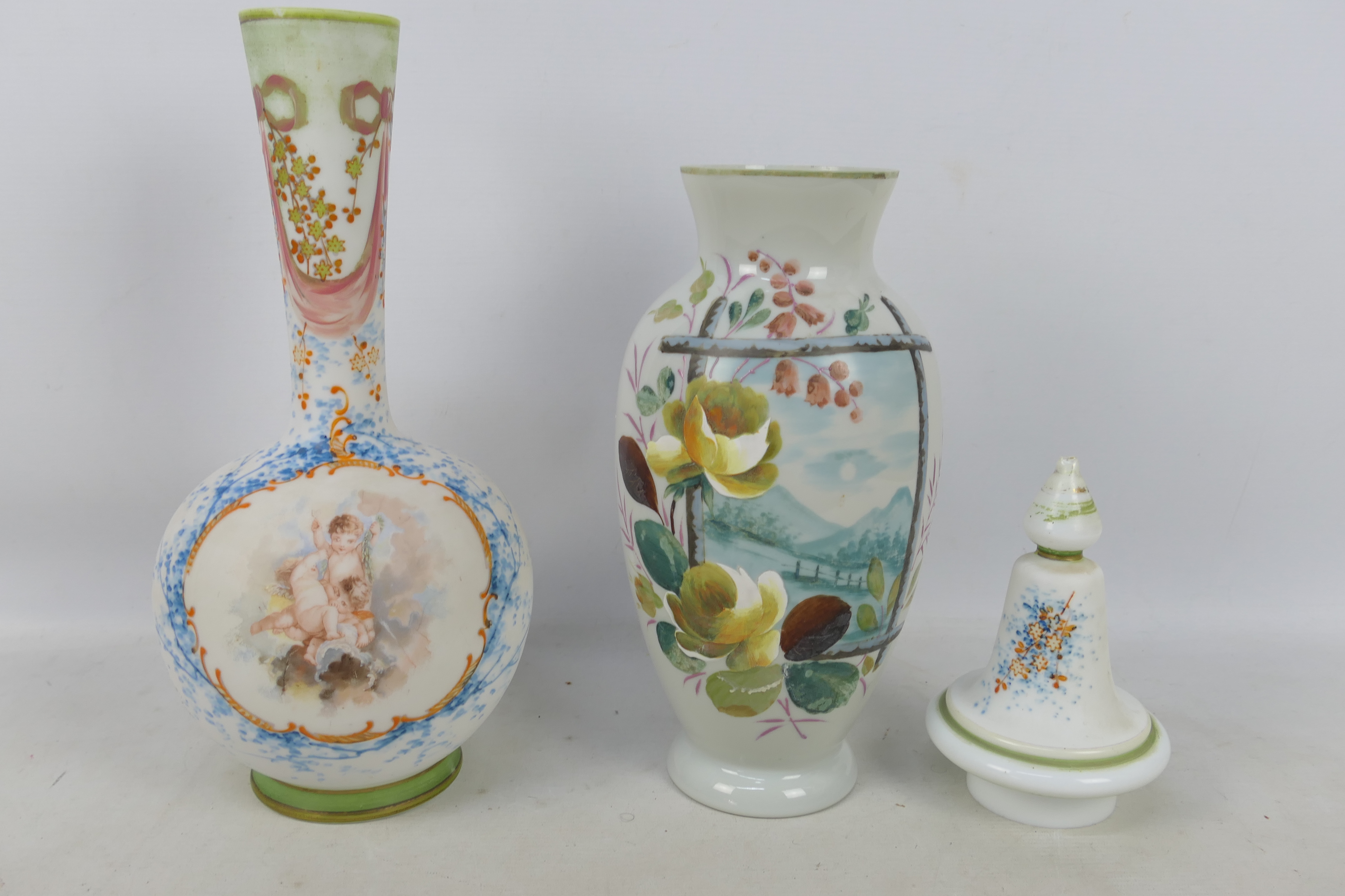Two glass vases with hand painted decoration, one with a panel of putti with foliate surround,