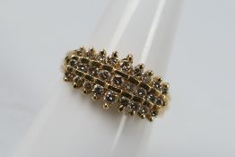 A 14ct yellow gold dress ring set with graduated brilliant cut stones, size N+½, approximately 4.