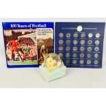 An ESSO FA Cup Centenary Collector Coin Set and a Disney Winnie The Pooh snow globe.