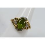 A 14ct yellow gold, peridot and diamond dress ring, size N+½, approximately 3.