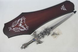 A decorative Fantasy sword / dagger with display board, approximately 63 cm (l).