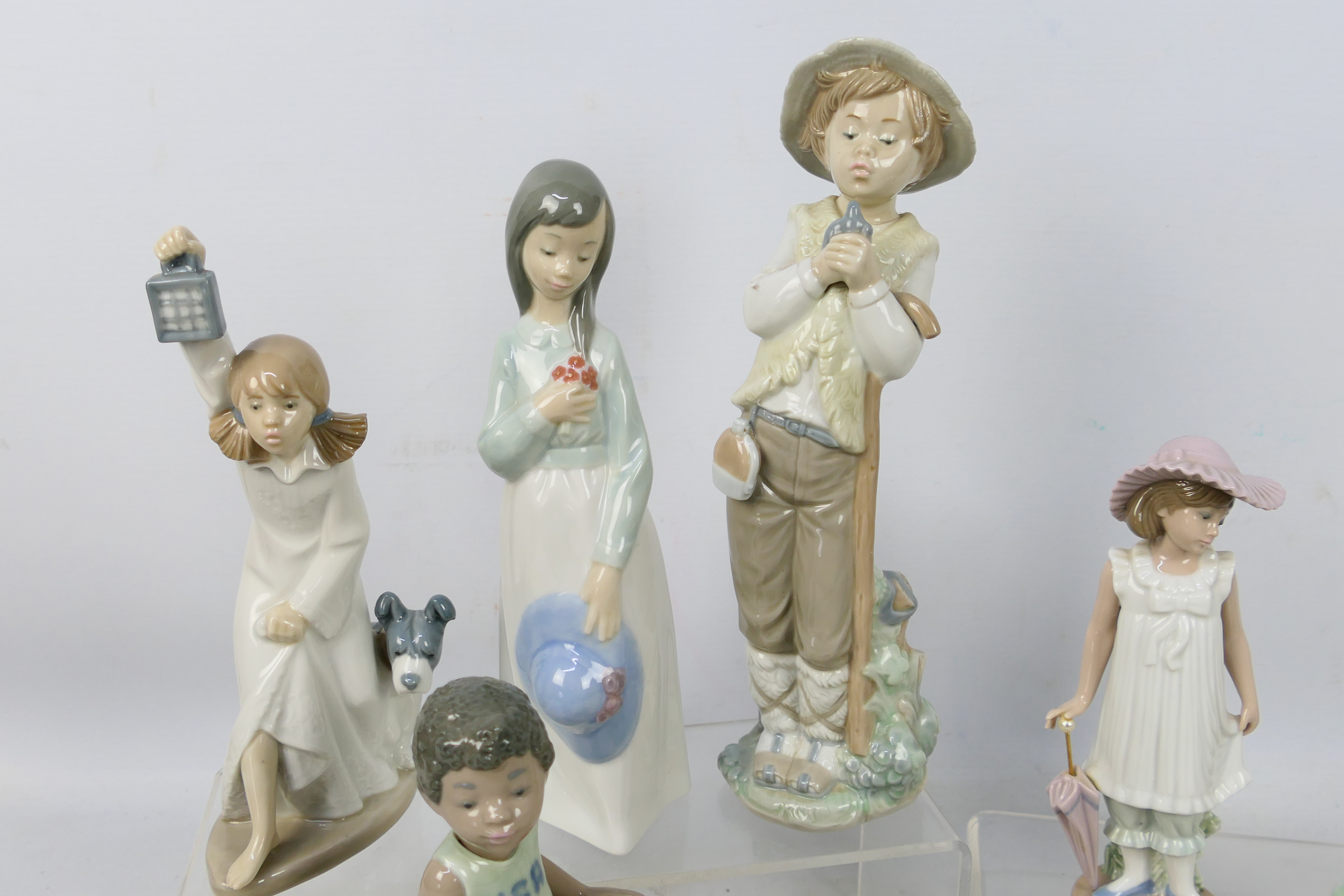 Eight Nao figures depicting children, largest approximately 27 cm (h). - Image 2 of 5