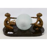 An Art Deco style figural table lamp with bronzed spelter female nudes and spherical lamp shade set