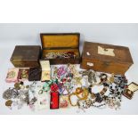 Three wooden boxes containing a quantity of costume jewellery and similar including a silver fob,