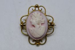 A yellow metal, stamped 9ct, openwork mount cameo brooch, 7.2 grams all in.