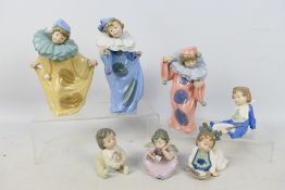 Nao - Three child clown figures, largest approximately 20 cm (h) and four others.