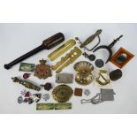 Militaria to include wooden club, cap badges, lapel badges, spur, sword hilts and guards and other.