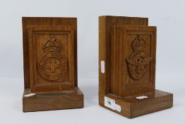 A pair of bookends one with carved Red Cross Society badge, the other with RAF,