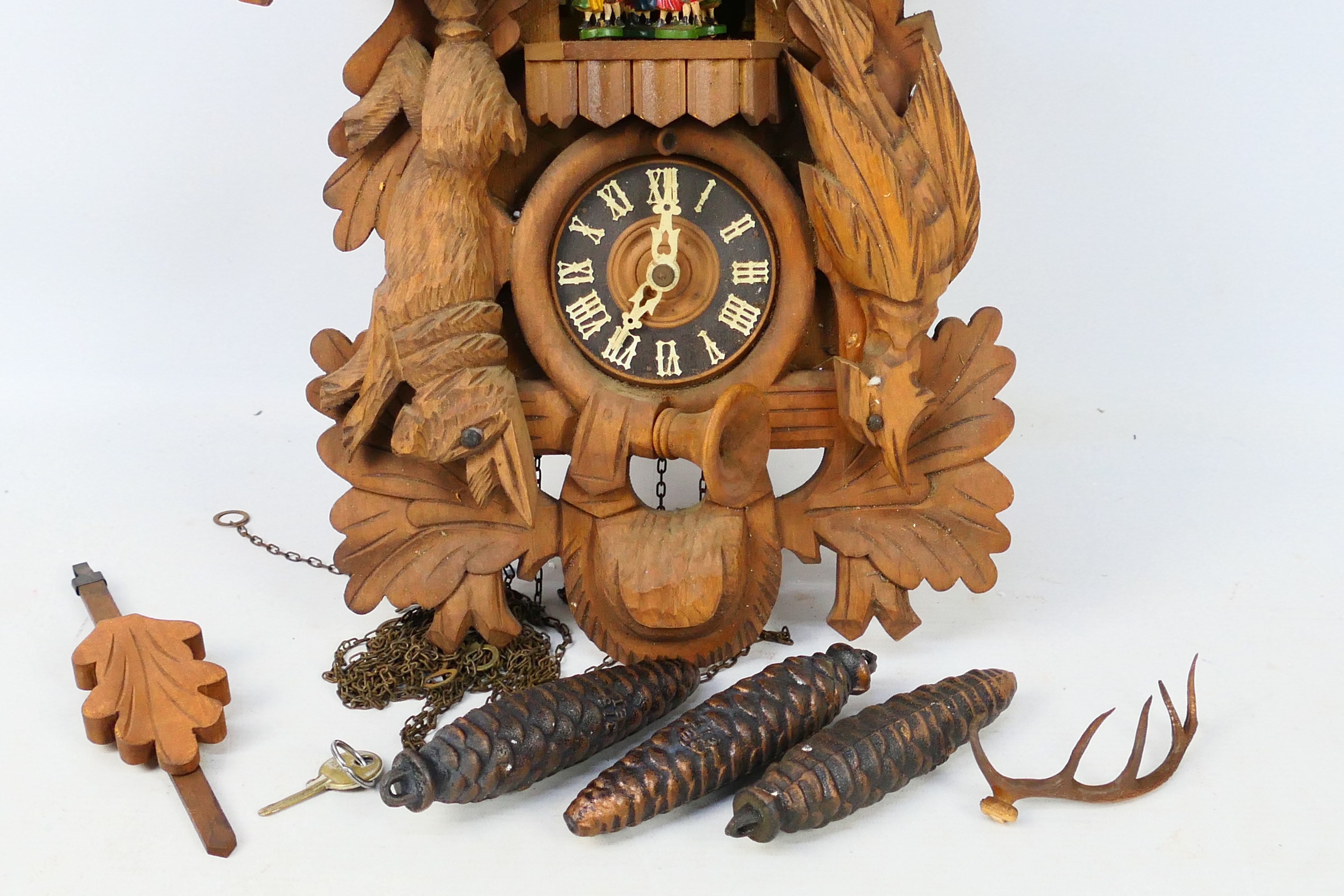 A black forest style cuckoo clock with game carved decoration, with pendulum and weights. - Image 2 of 8