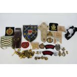 Militaria to include cap badges, cloth patches, buttons and other.