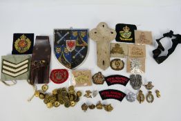 Militaria to include cap badges, cloth patches, buttons and other.