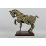 A Japanese cast metal model of a horse mounted to wooden plinth, approximately 24 cm (h).